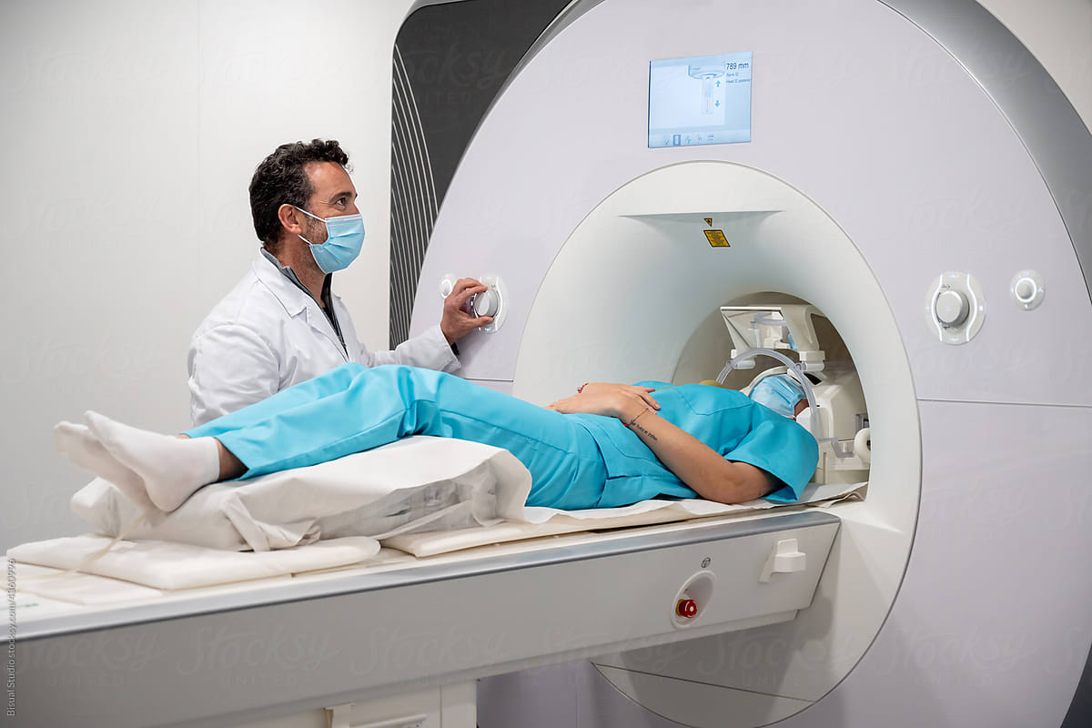 Doctor doing MRI procedure in clinic