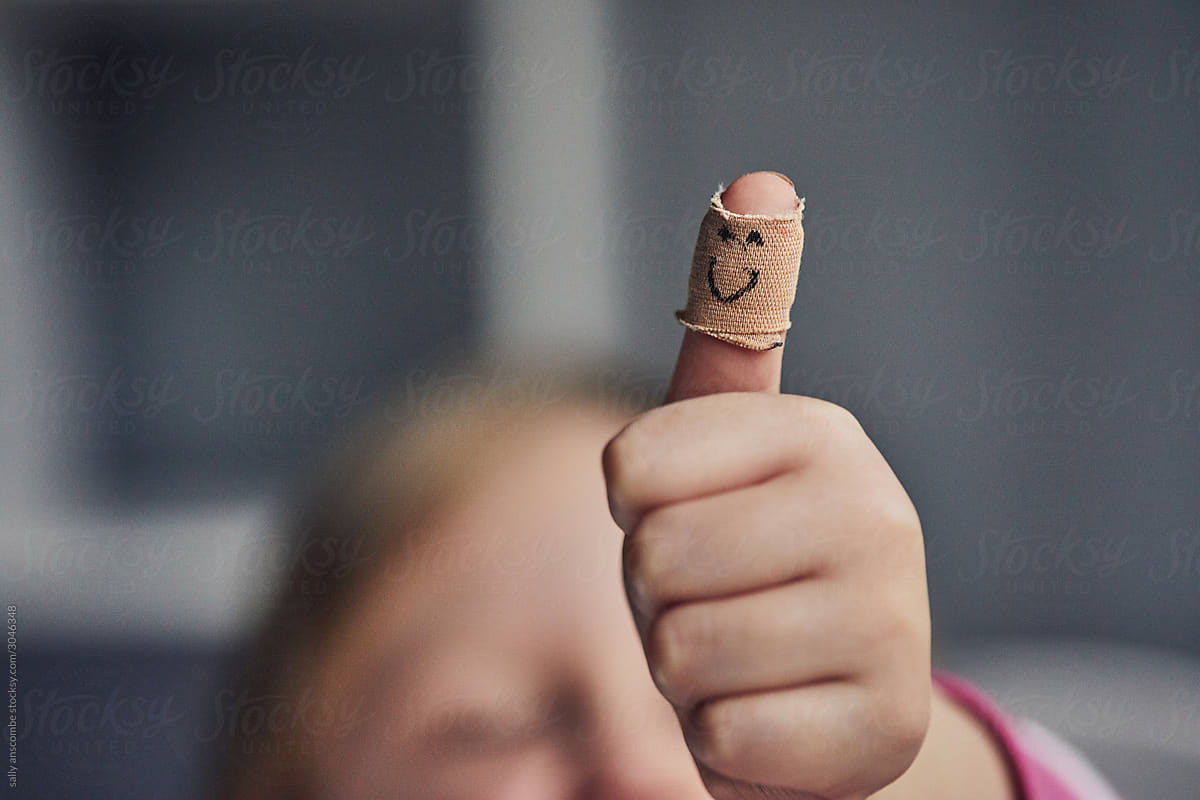 Child with a plaster on her injured thumb