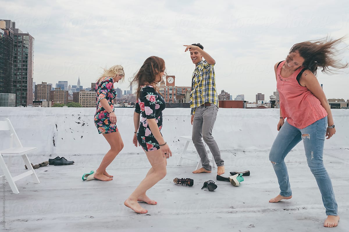 Friends Having Fun And Dancing On A New York Rooftop By Stocksy Contributor Joselito Briones