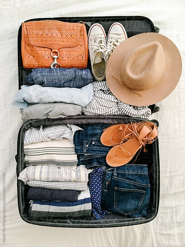 Suitcase with packed clothes and accessories