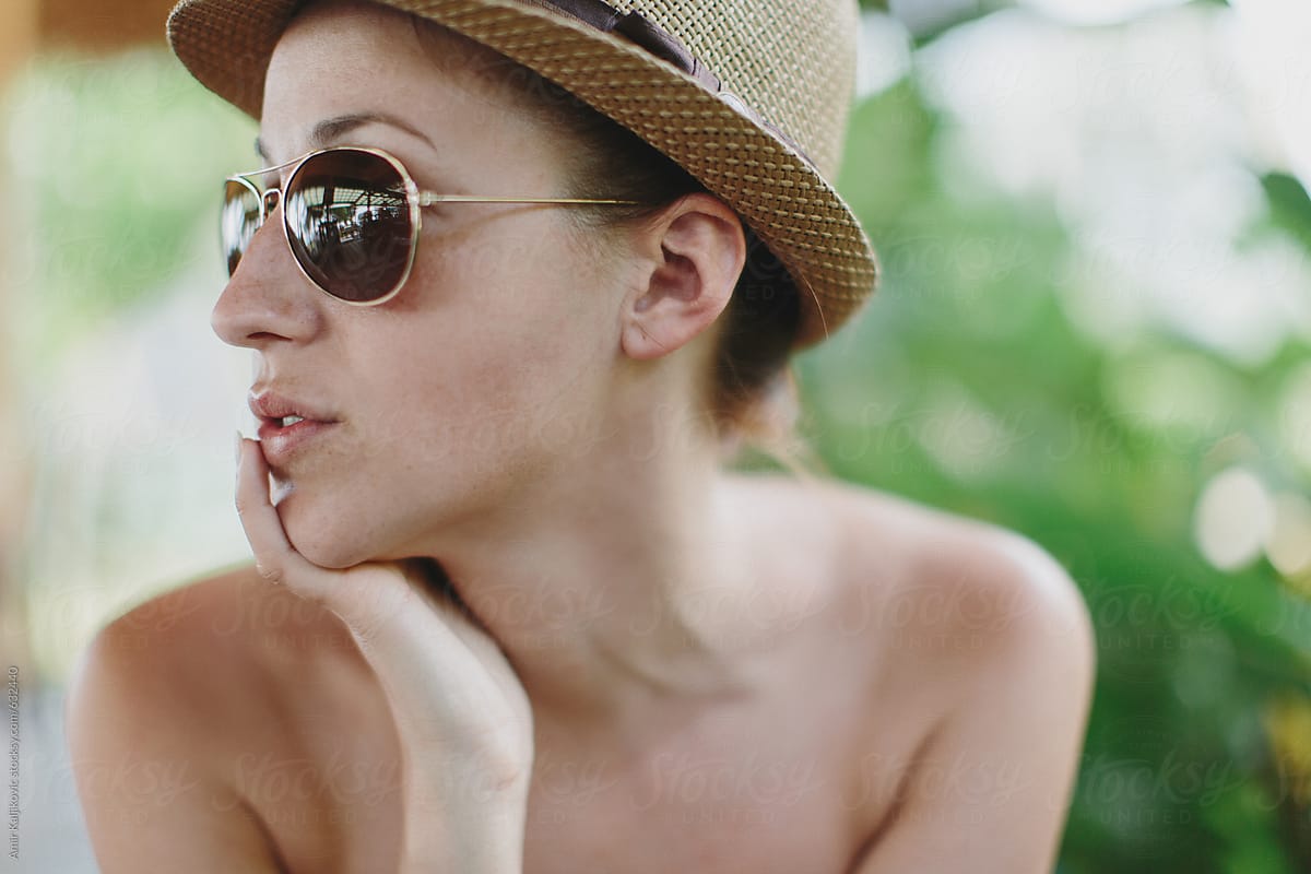 Stylish Woman Wearing Sunglasses and Brown Hat