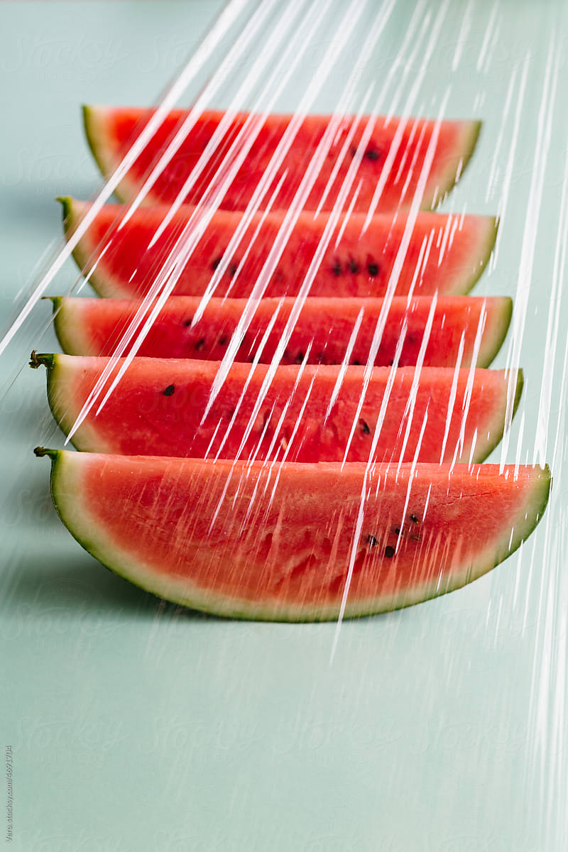Slices of watermelon seen through a plastic film