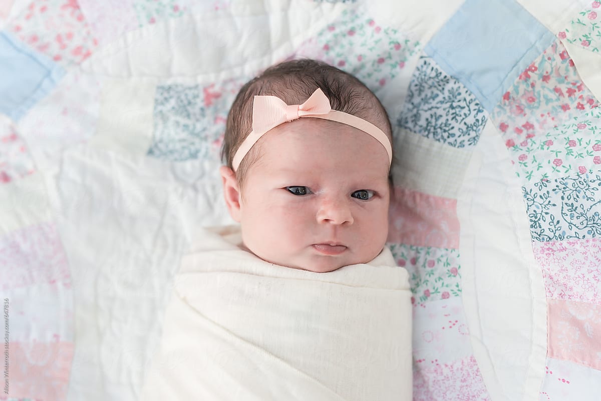Sweet Newborn Girl Swaddled On A Vintage Quilt