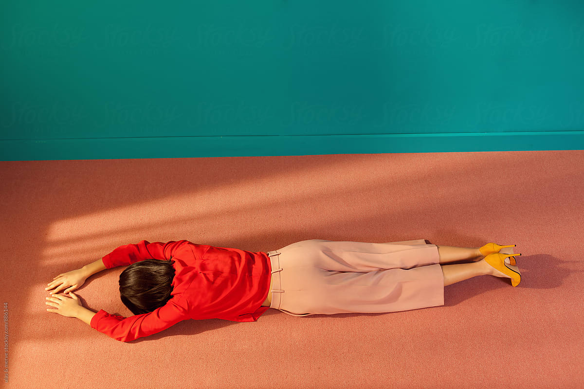 Woman Lying Down On The Floor Of A Room by Stocksy Contributor  Ulas&Merve - Stocksy