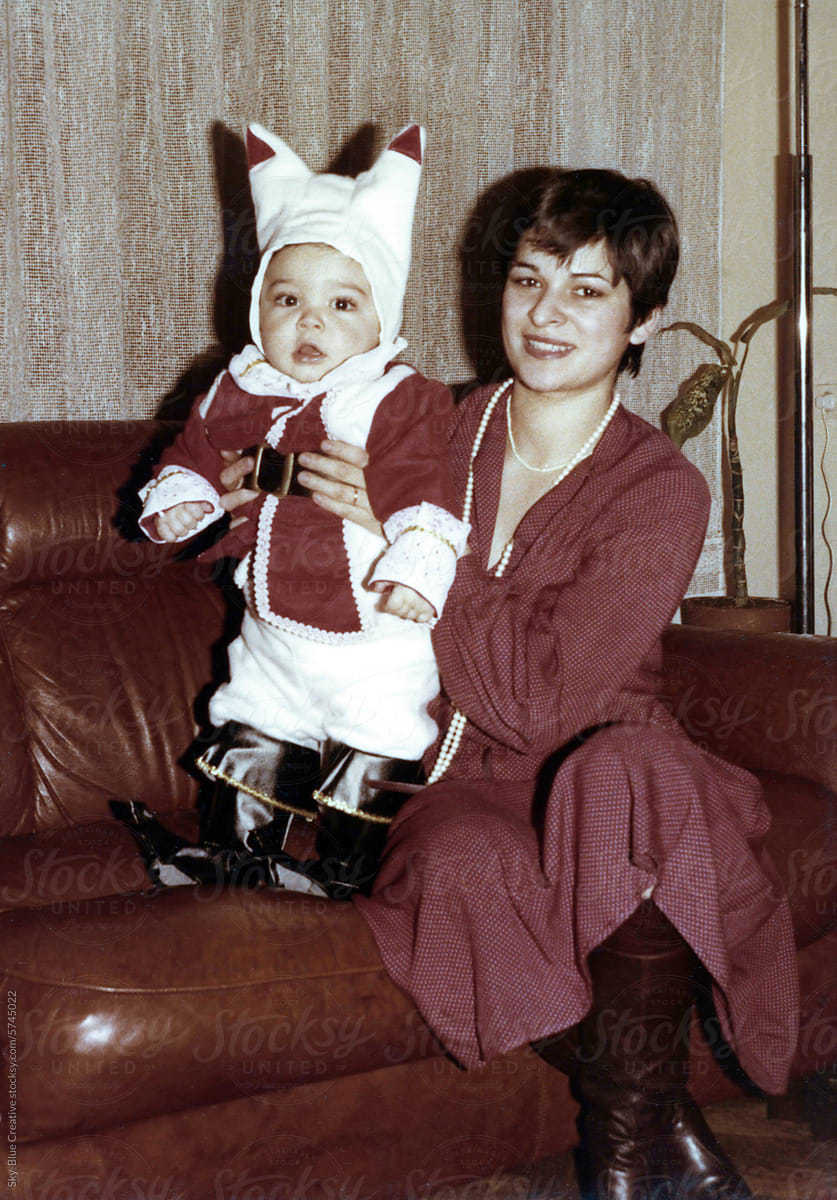 1979: One-Year-Old in Carnival Costume on Home Sofa with his mother