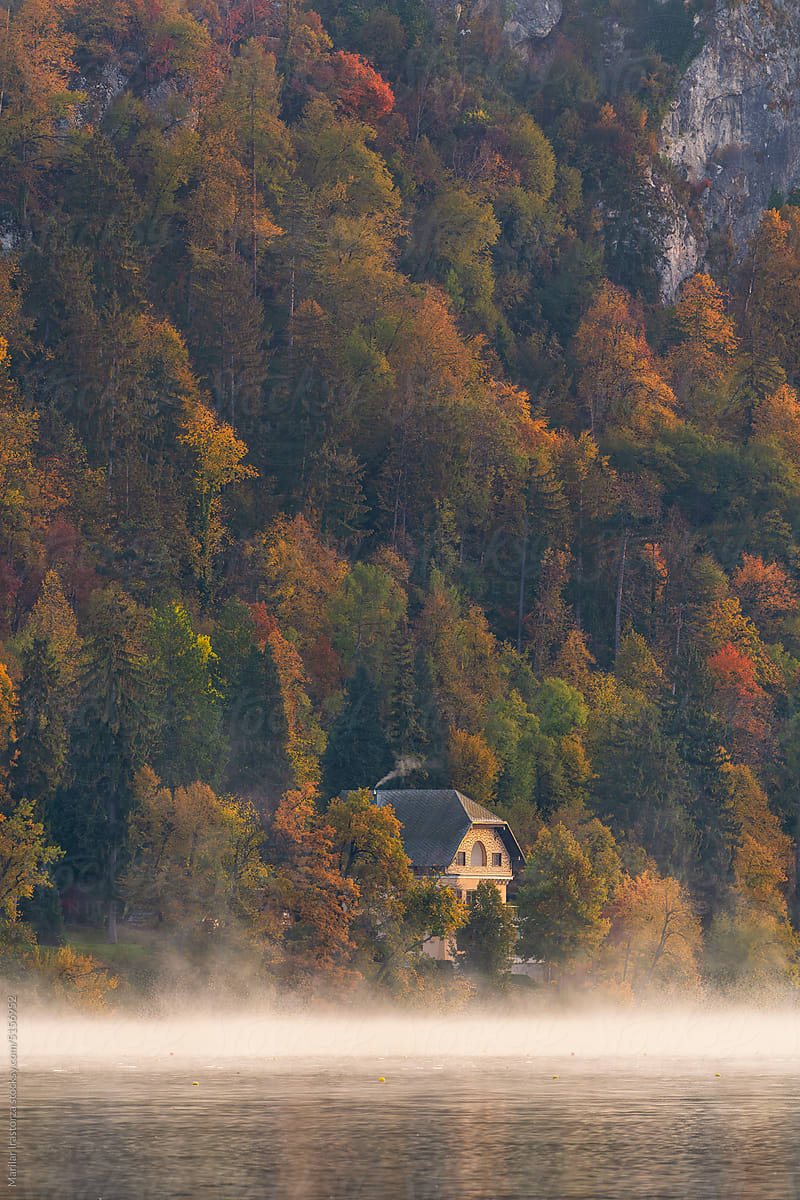 House On The Shore Of A Misty Lake In Autumn