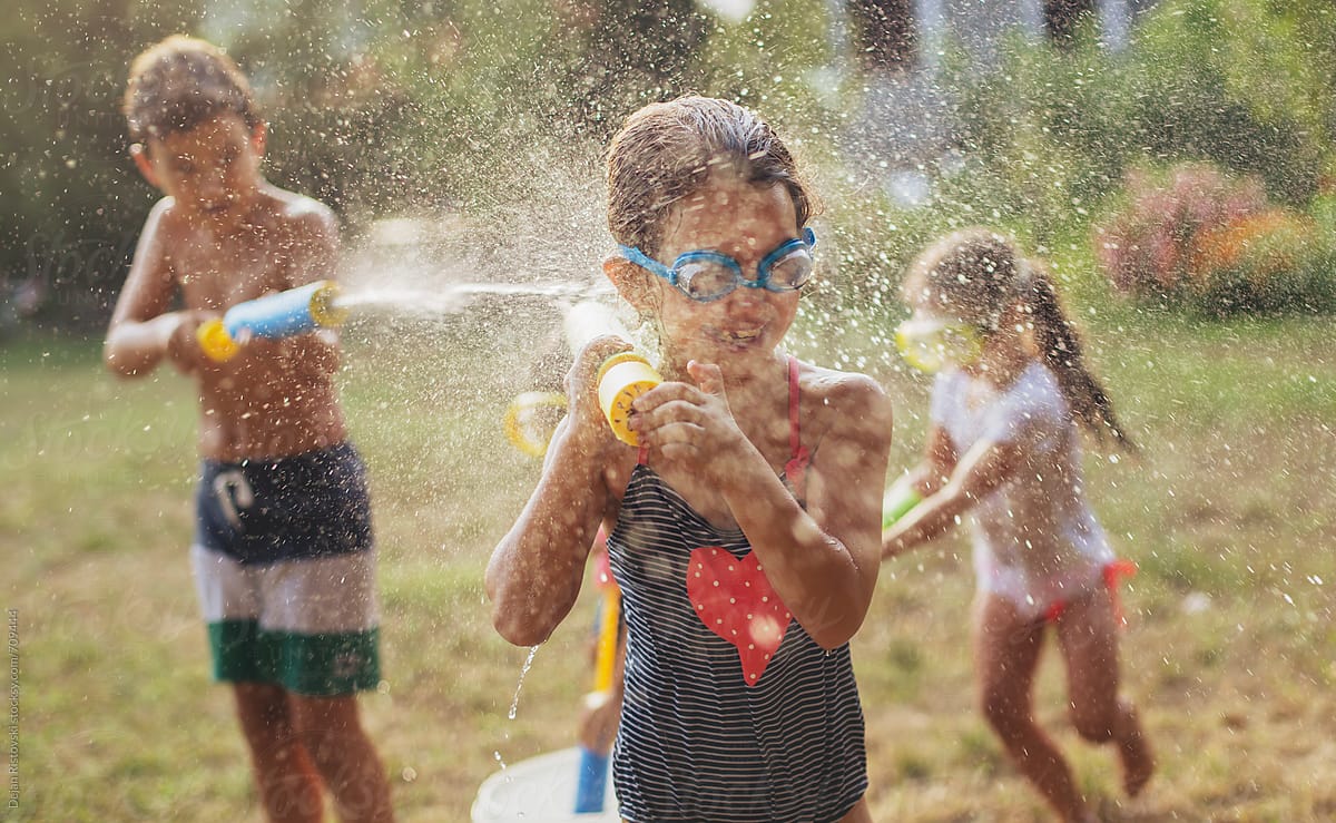 Children splashing with water guns.