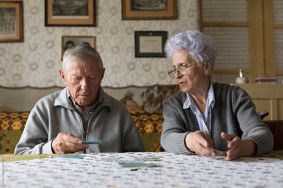 Senior couple playing card game