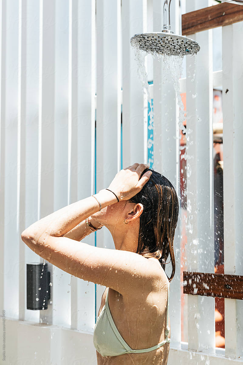 Woman showering at beautiful outdoor shower