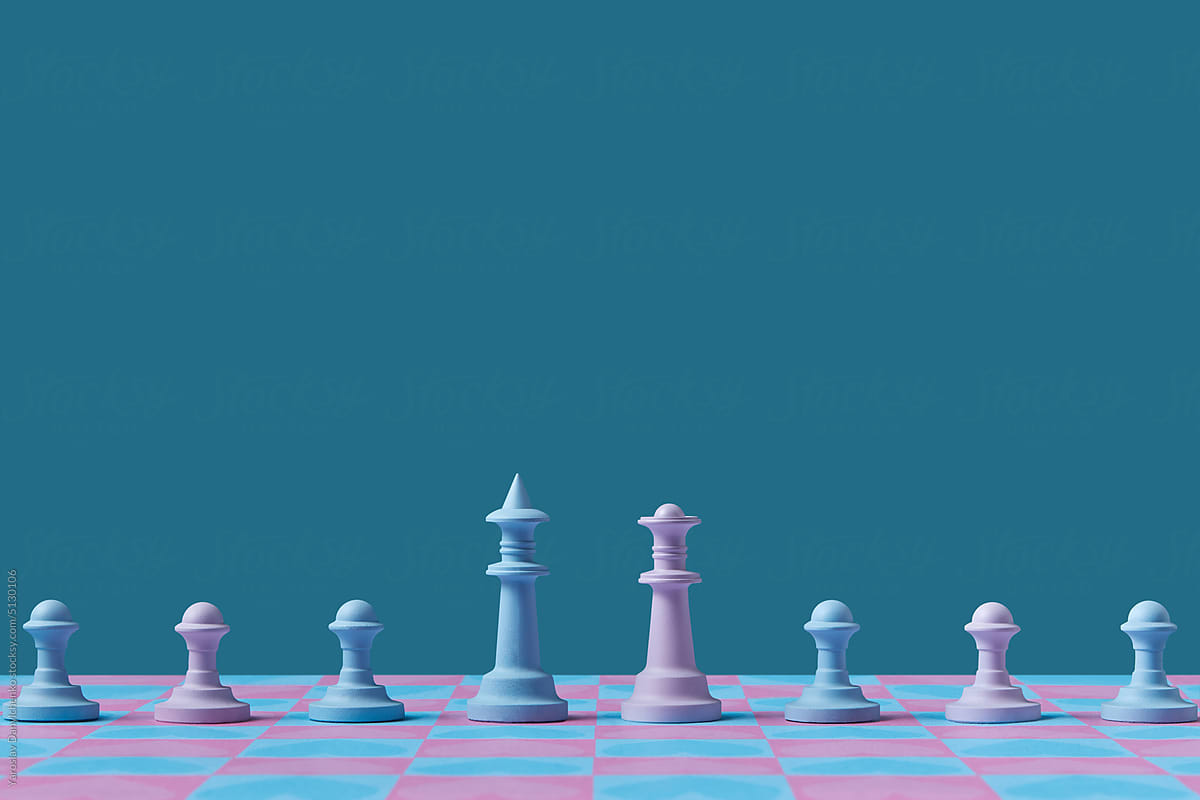 Blue and pink chess figures on chessboard.