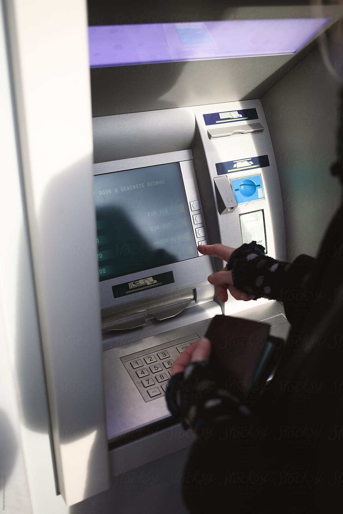 Woman using an atm machine in Holland