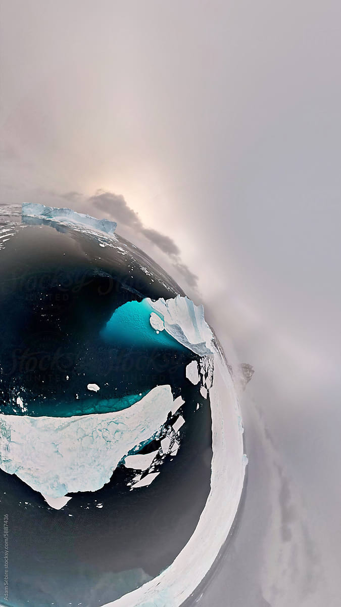 Tiny planet of sea ice and underwater iceberg