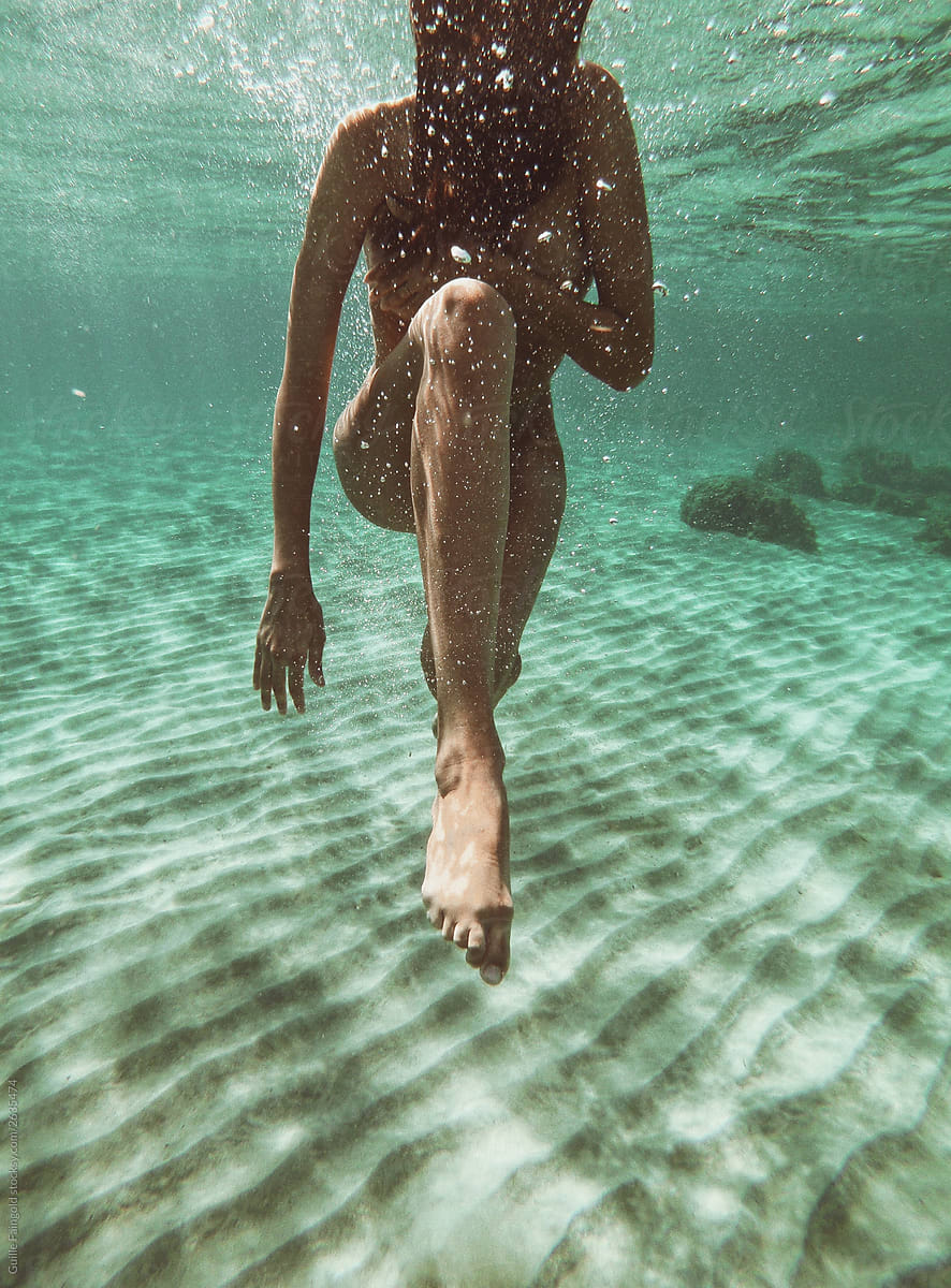 Naked woman underwater.