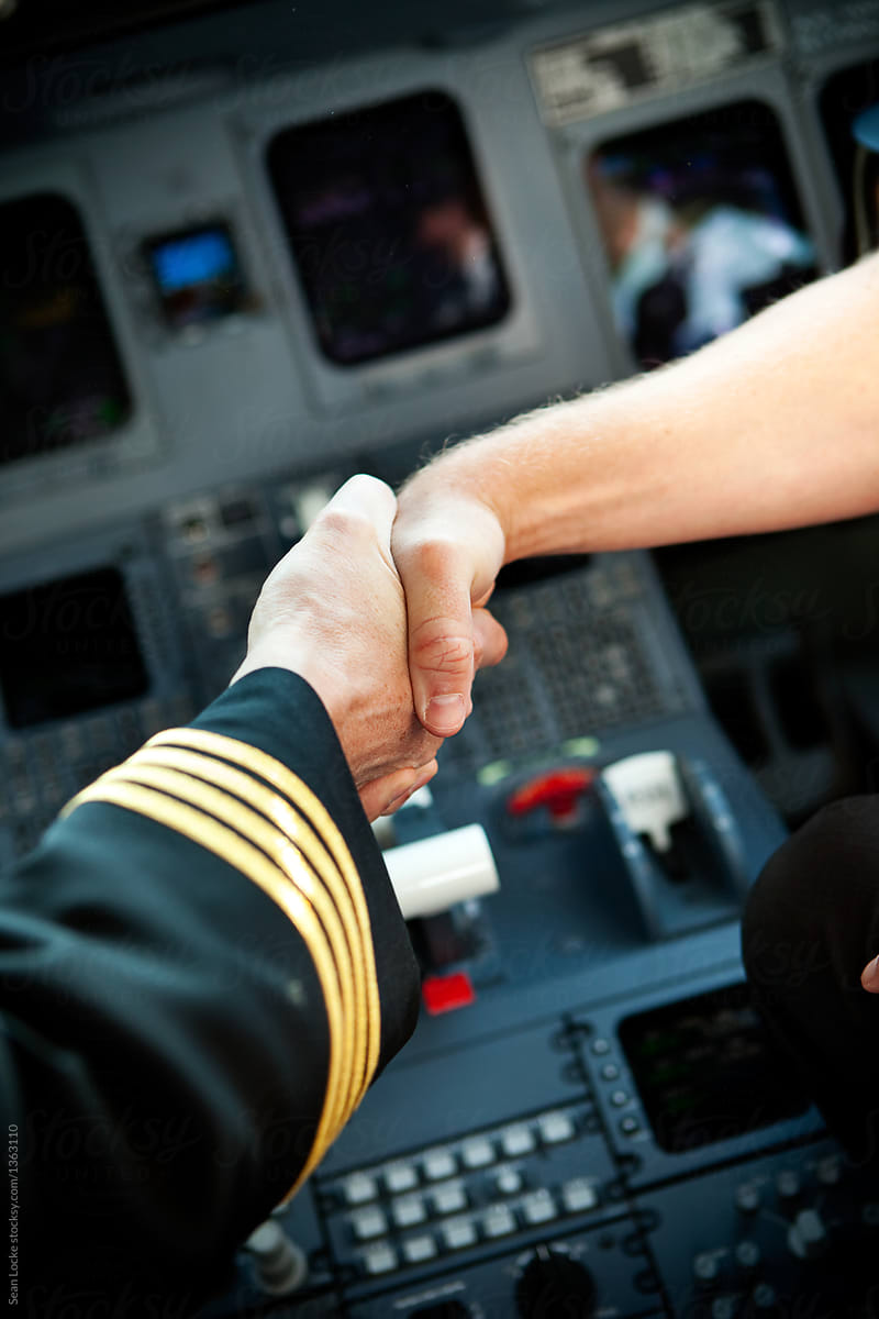 Plane: Captain And Crew Shaking Hands In Cockpit