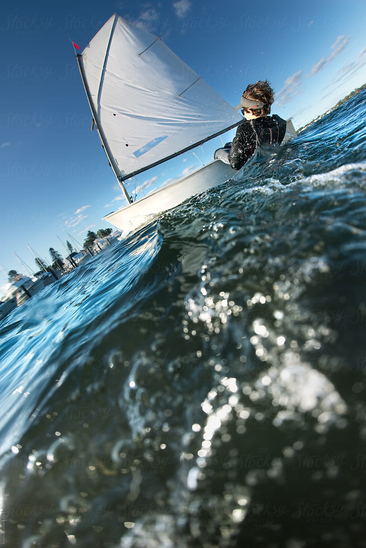 Action capture of a child sailing an optimist dinghy