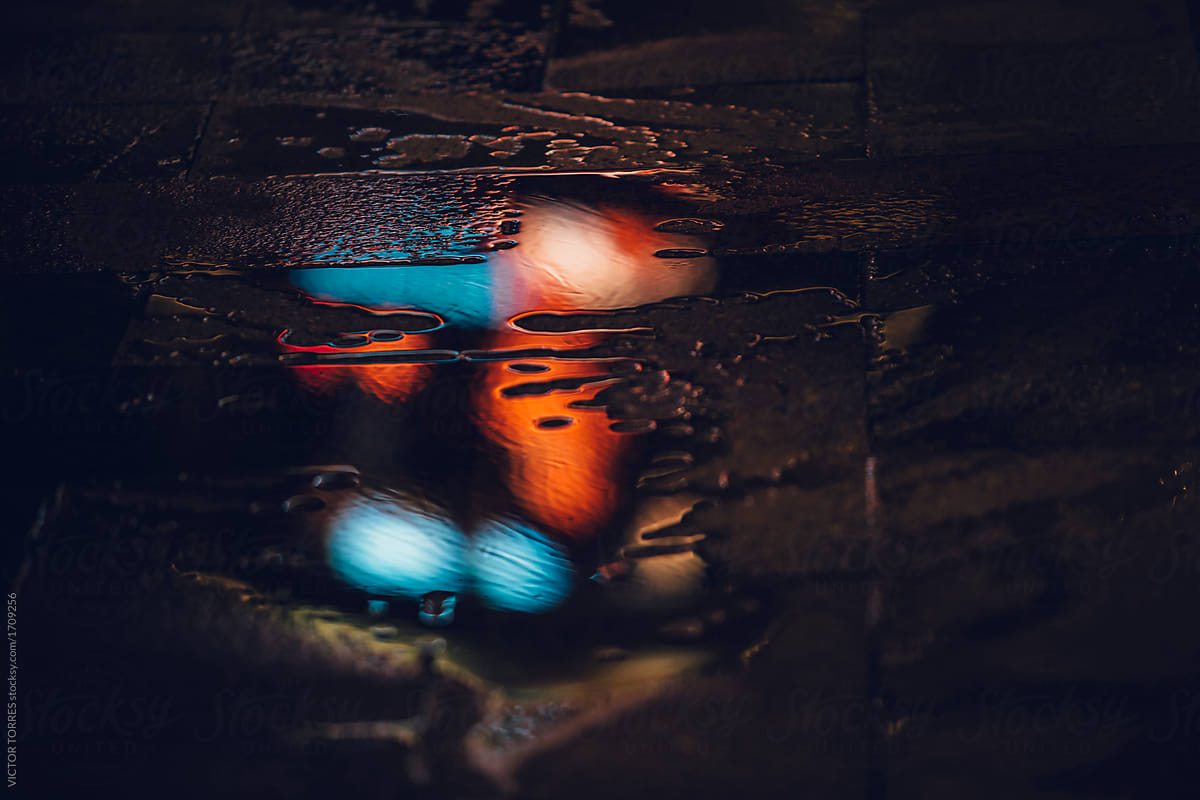 Color lights reflected on puddle