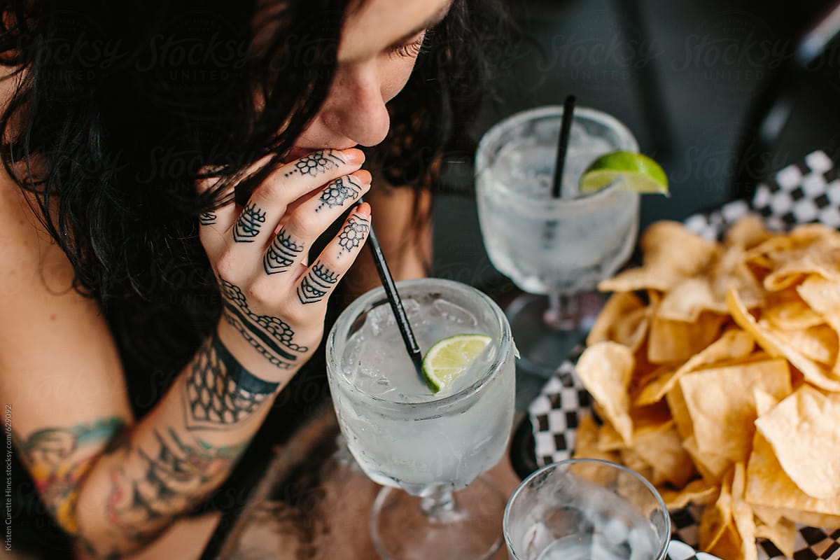 A woman enjoying happy hour at a local mexican restaurant