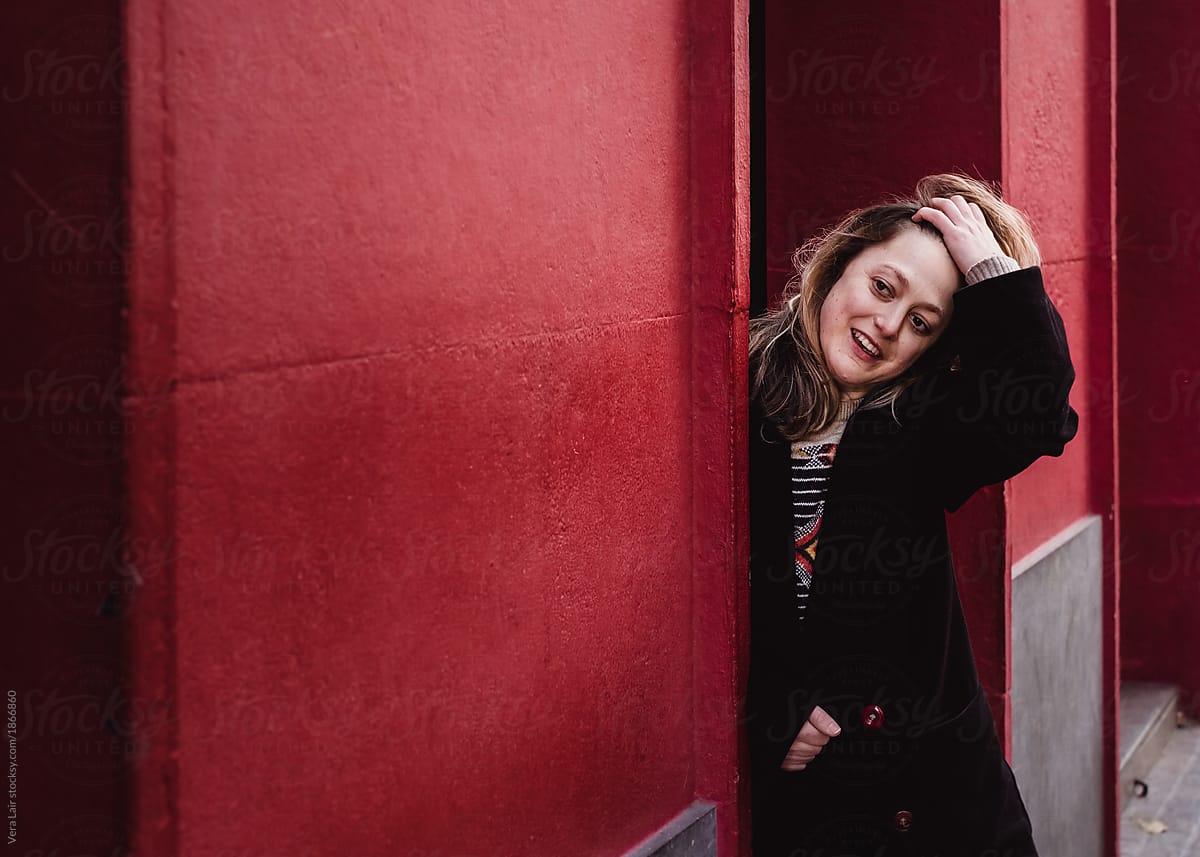 «young Woman Hidden Behind A Red Wall Del Colaborador De Stocksy «vera