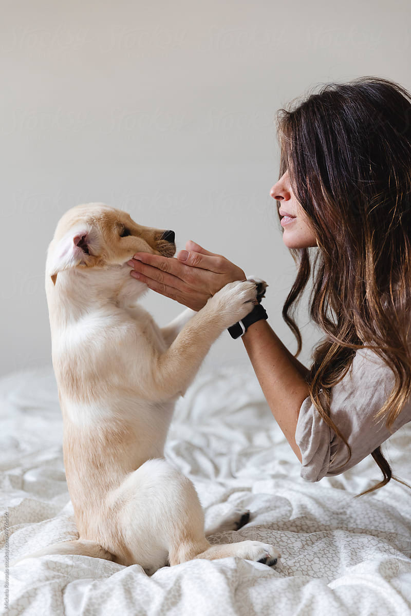 Woman playing with her puppy
