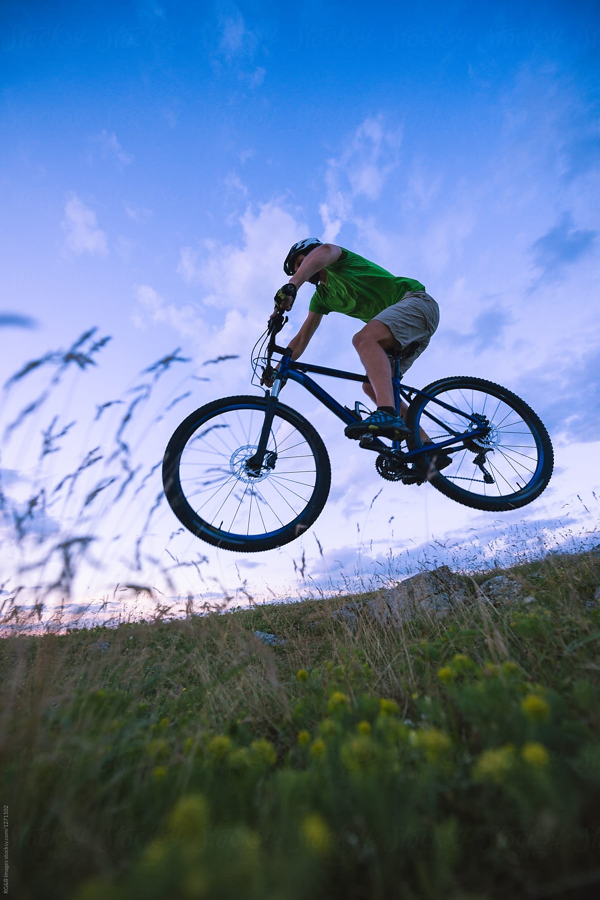 Caucasian man jumping with mountain bike off road