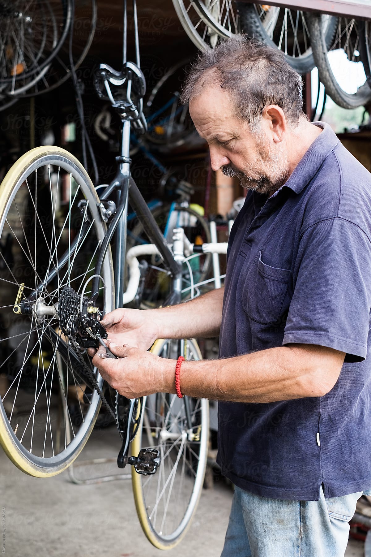 Man Repairing Bicycle Chain
