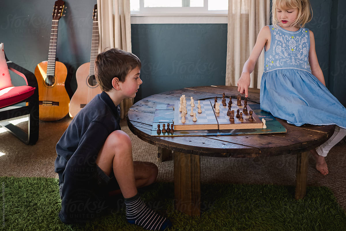 two children playing a game of chess