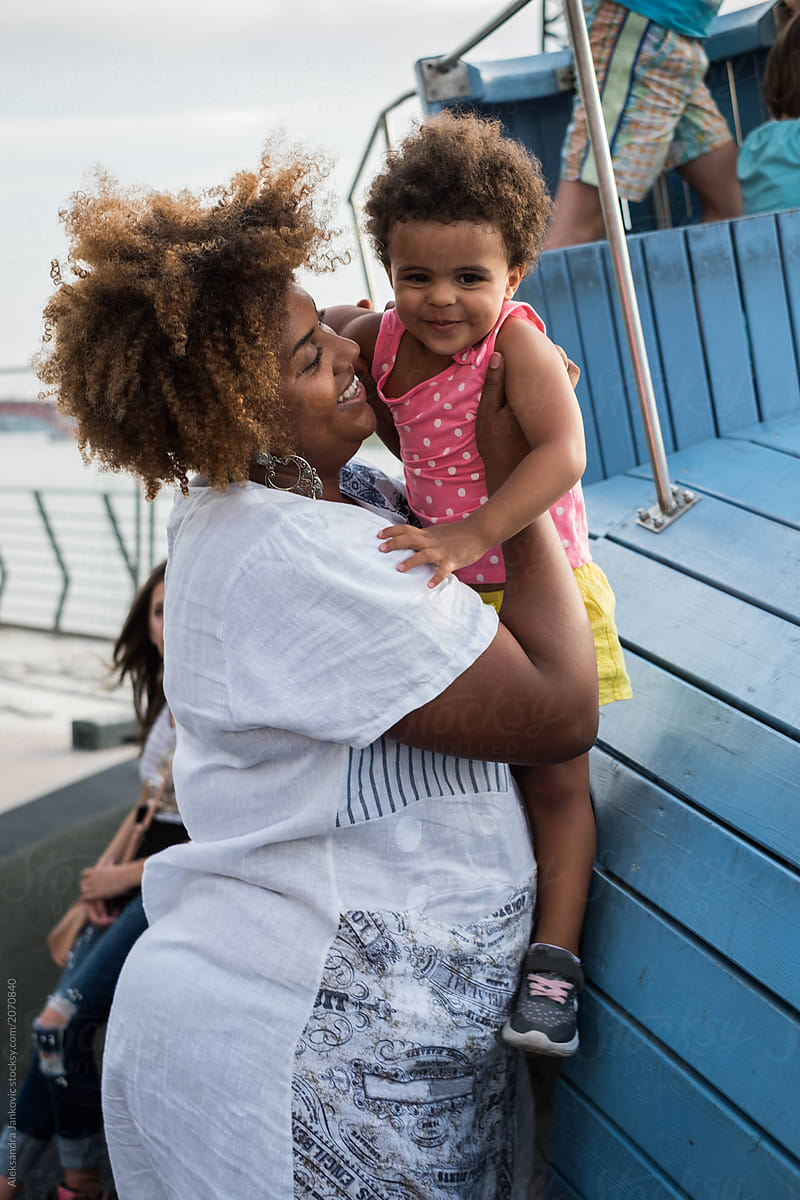 Smiling Black Woman With Her Child Having Fun At The Playground