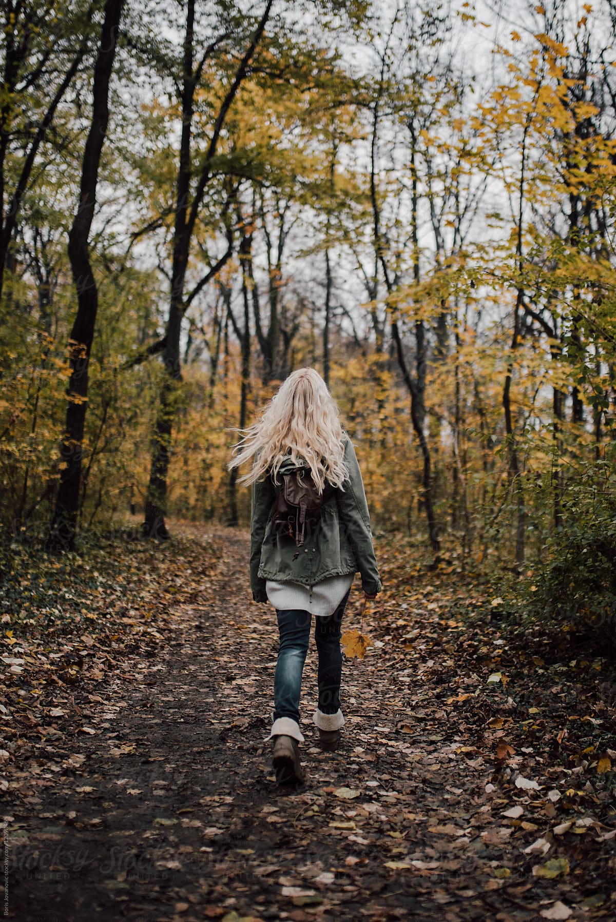 Backside View Of A Blonde Woman Walking Through Woods By Stocksy Contributor Boris Jovanovic 