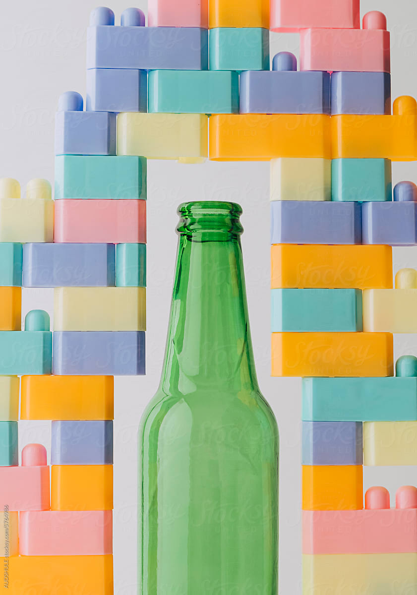 bottle surrounded with toy bricks
