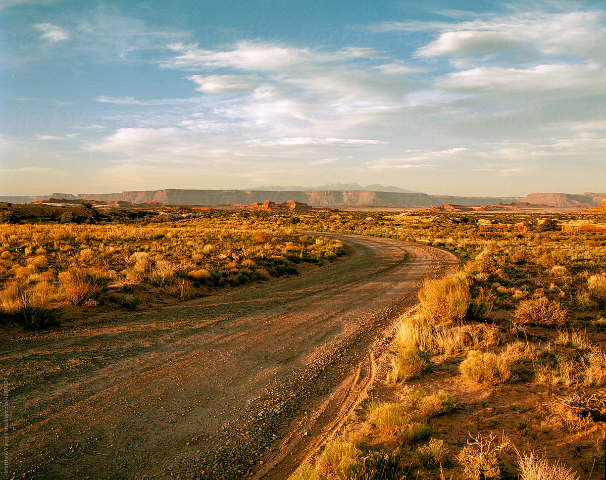 A dirt road leading through the Utah desert