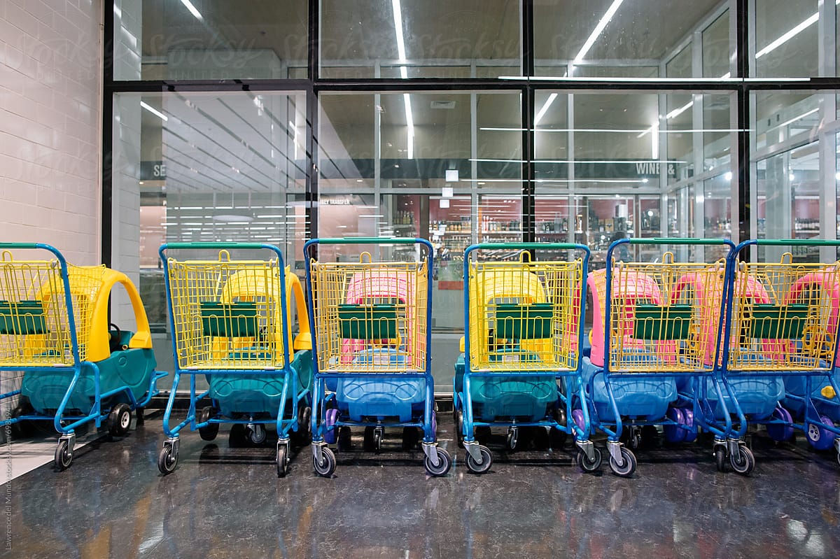 Colorful kiddie shopping carts lined up at the supermarket
