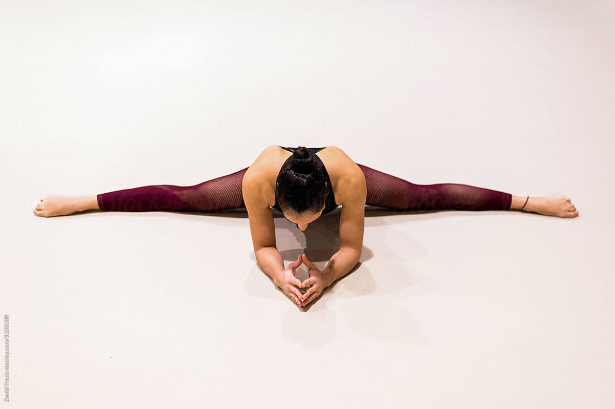 young artistic gymnast woman performing and training stretching
