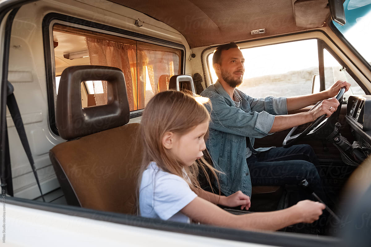 Daughter riding van with father