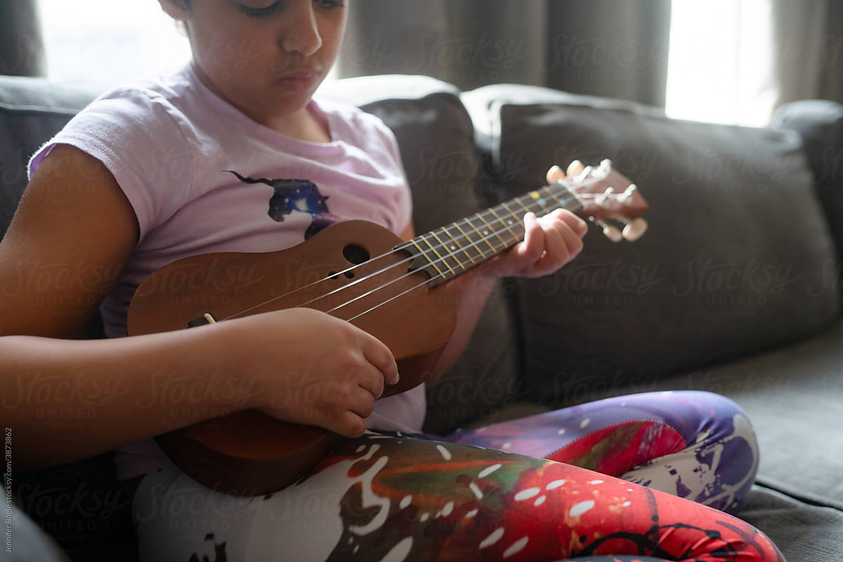 Closeup of ukulele in girl's lap