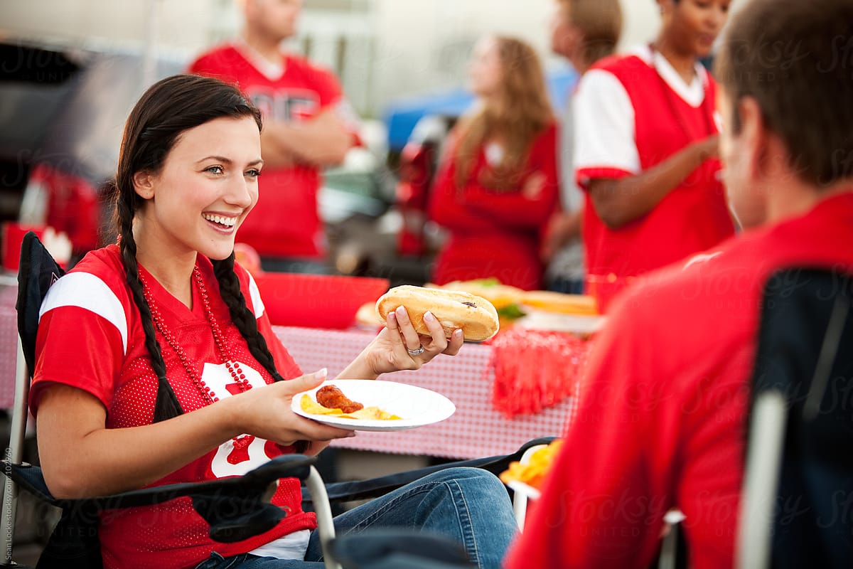 Tailgating: Woman Laughing and Eating Hot Dog