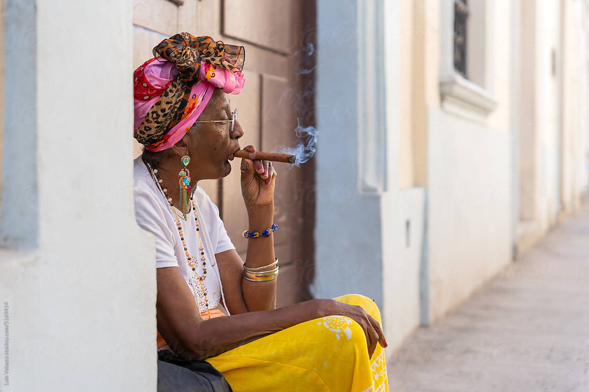 Black Woman Smoking A Cigar In Cuba.