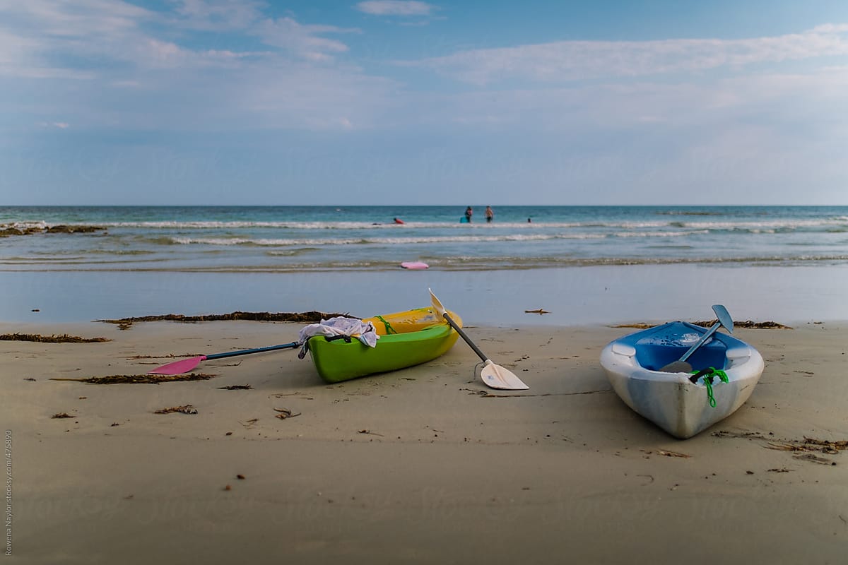 Kayaks left on summer beach