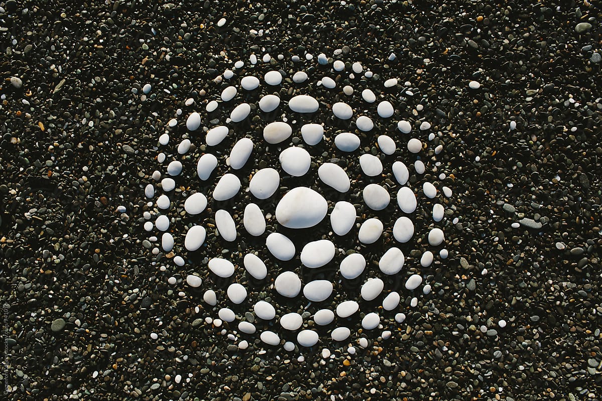 white stones arranged in circular pattern on beach