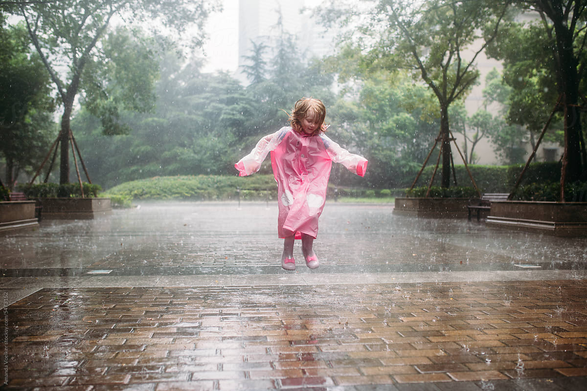 Little Girl jumping in the rain