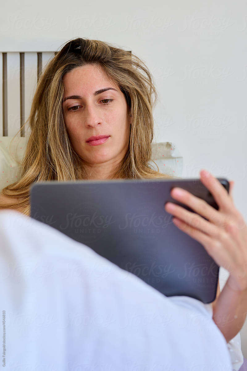 Woman using tablet in morning