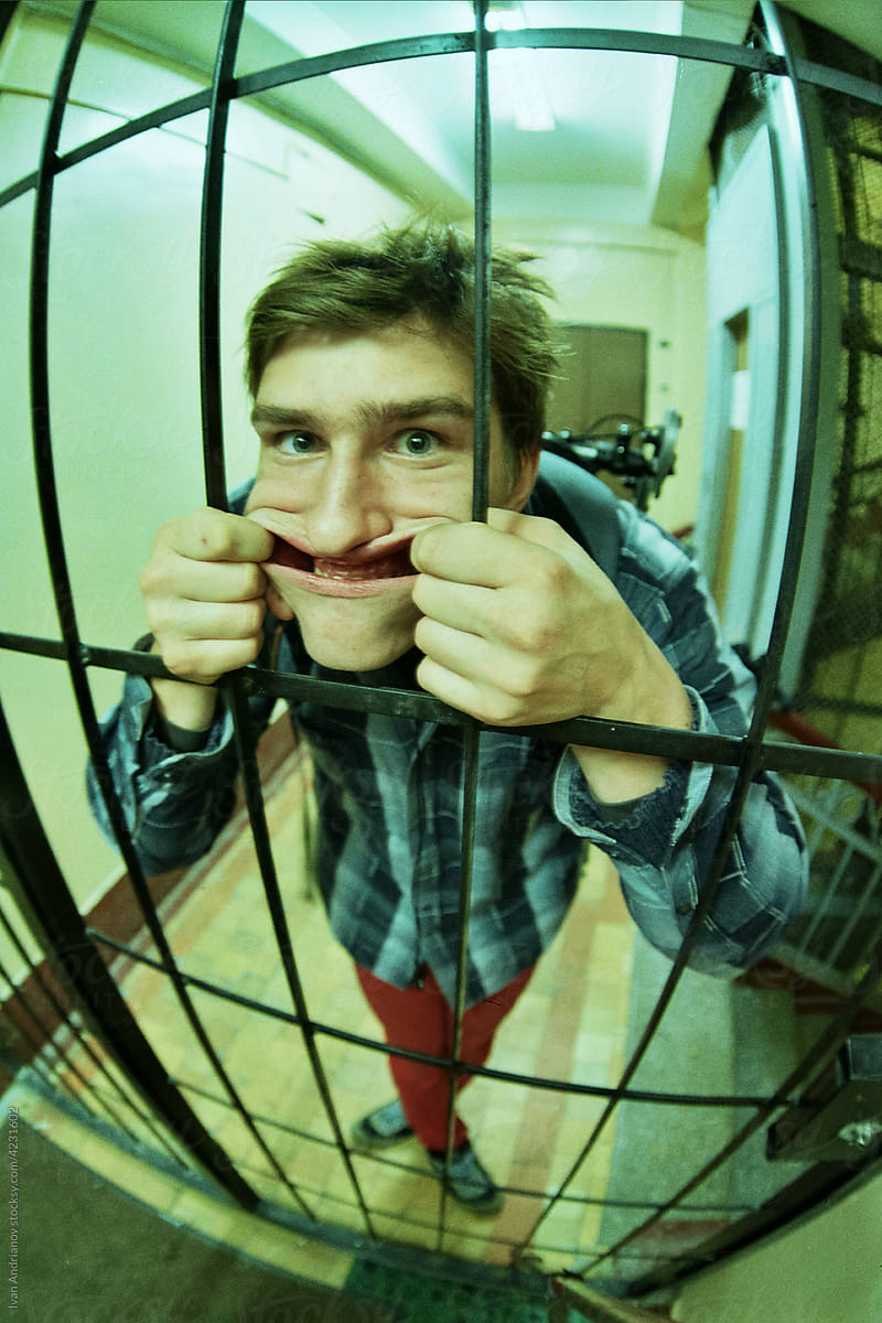 Man With Fake Smile Behind the Cage Fisheye Portrait