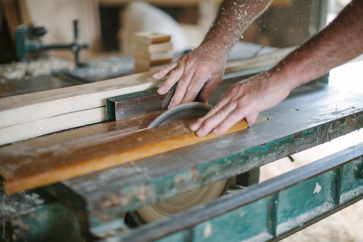 Carpenter Sawing a Board