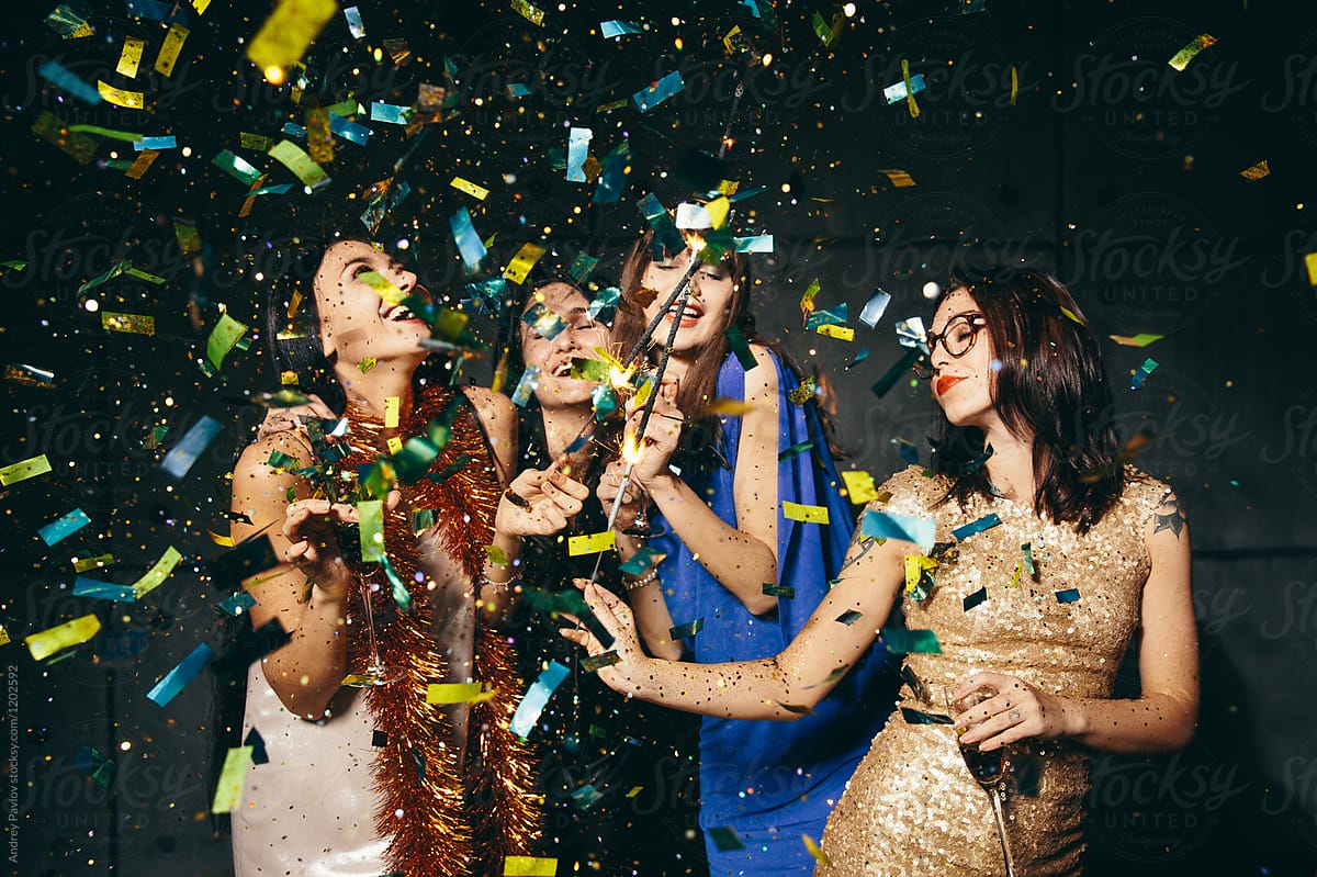 Four female in confetti having fun
