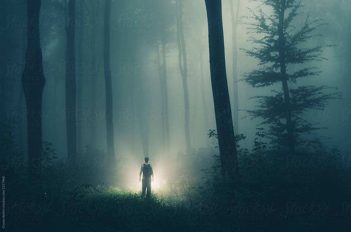 Alien in dark mysterious forest with strange light