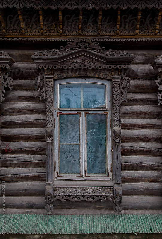Window of an old Russian house with carved architraves