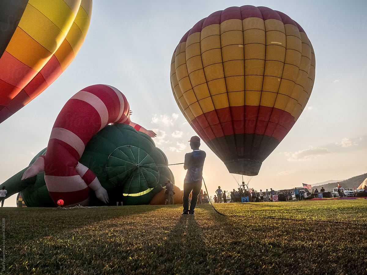 A man lifts up a huge balloon at a Balloon festival