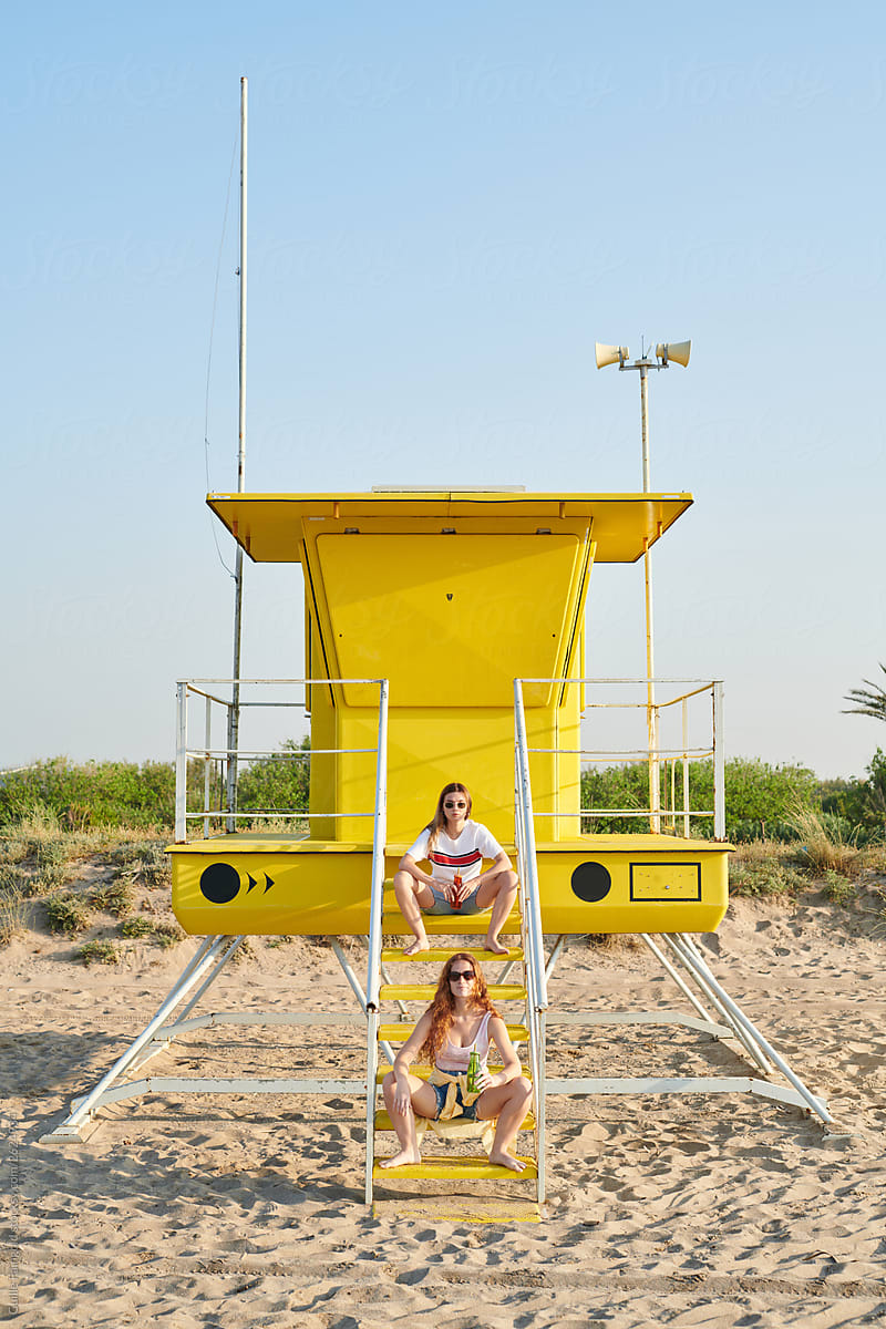 Two girls on the beach rescue tower.