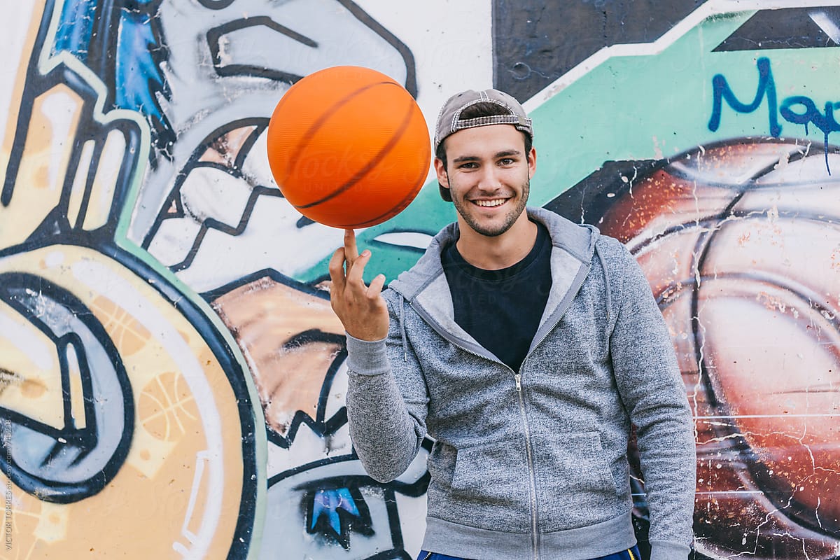 Young Happy Man Showing His Skills with a Basket Ball