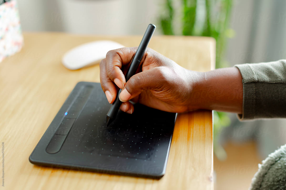 Woman\'s hand using pen tablet for computer design