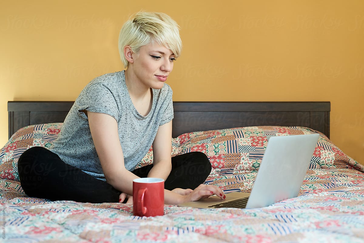 woman with pixie haircut using laptop